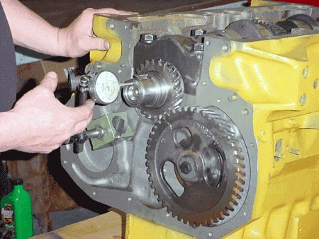 Man measuring engine part